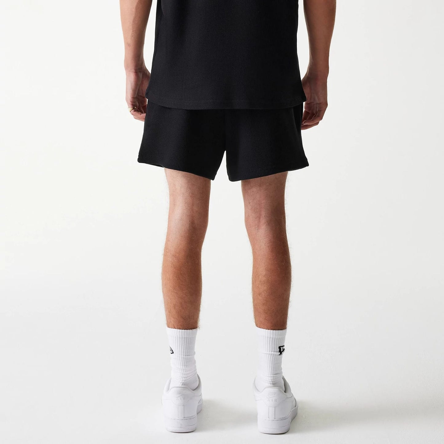 The Male model is wearing New Era Waffle Black Shorts 2