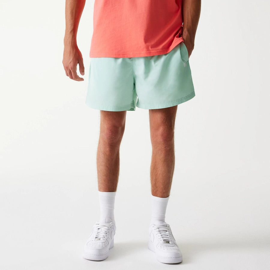 The Male model is wearing New Era Pastel Green Swim Shorts 1