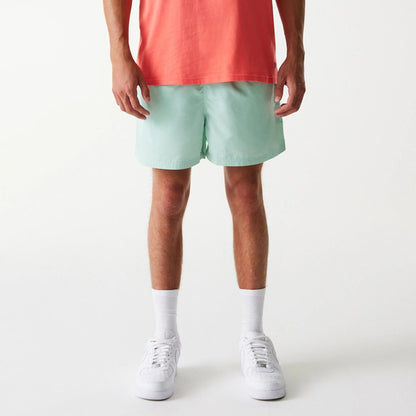 The Male model is wearing New Era Pastel Green Swim Shorts 8