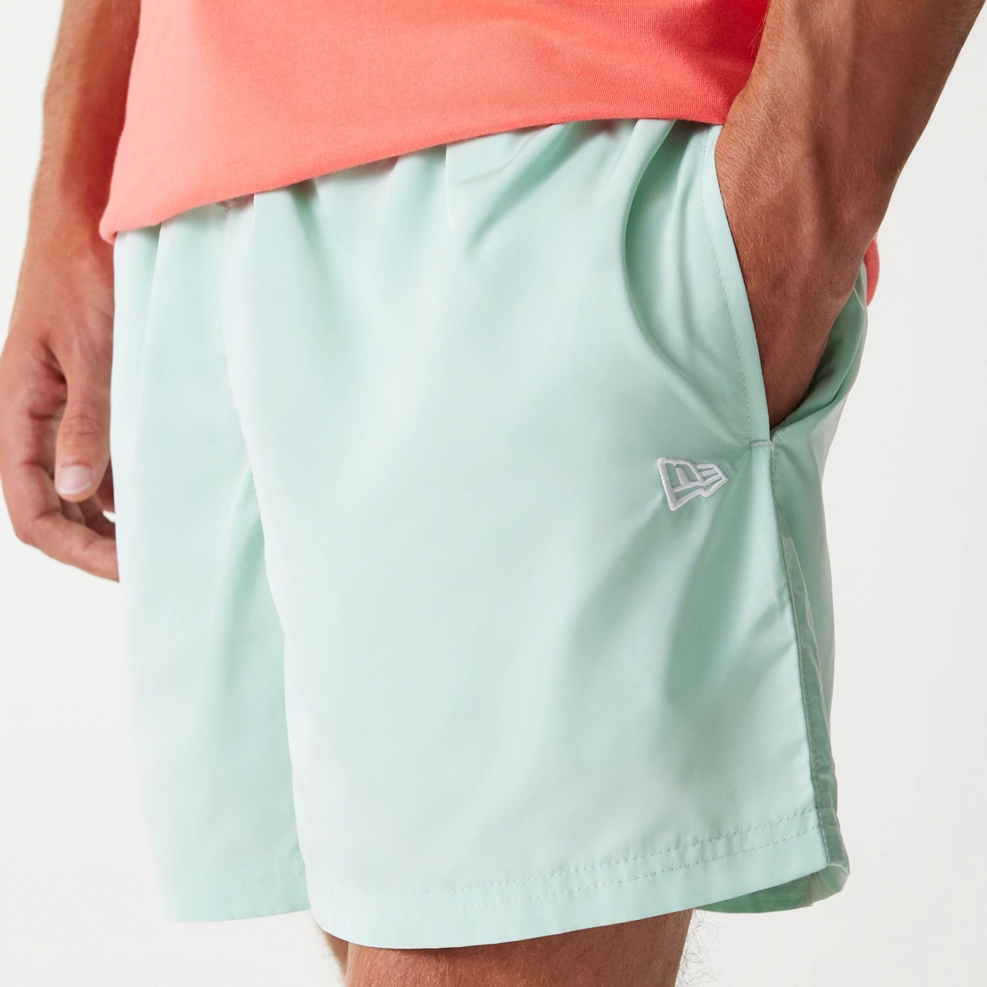 The Male model is wearing New Era Pastel Green Swim Shorts 4