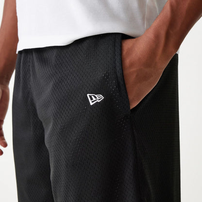 The Male model is wearing New Era Black Mesh Shorts 6