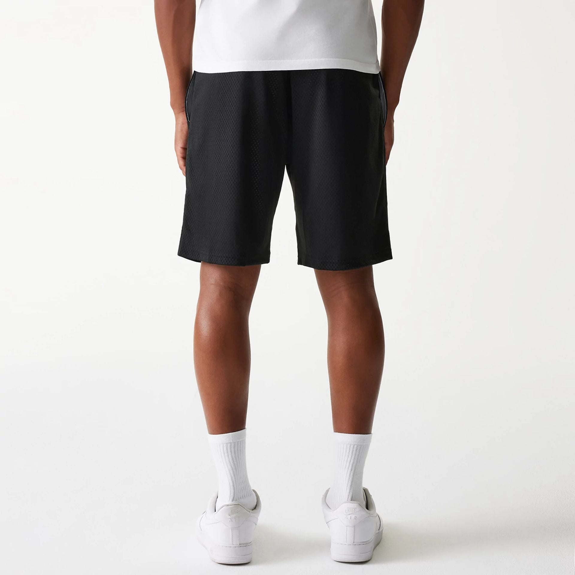The Male model is wearing New Era Black Mesh Shorts 2