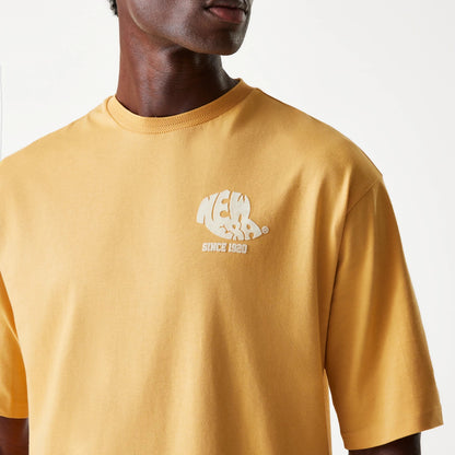 New Era Graphic Beige Oversized T-Shirt, front view featuring a beige oversized shirt with a rounded neckline and a white embossed New Era logo and Since 1920 text on the left chest side.