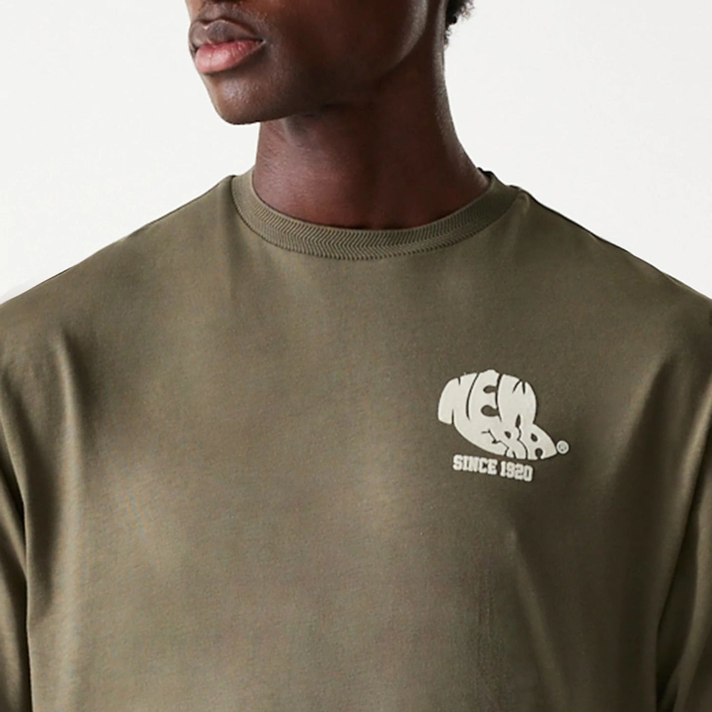 The Male model is wearing New Era Graphic Green Oversized T-Shirt 6