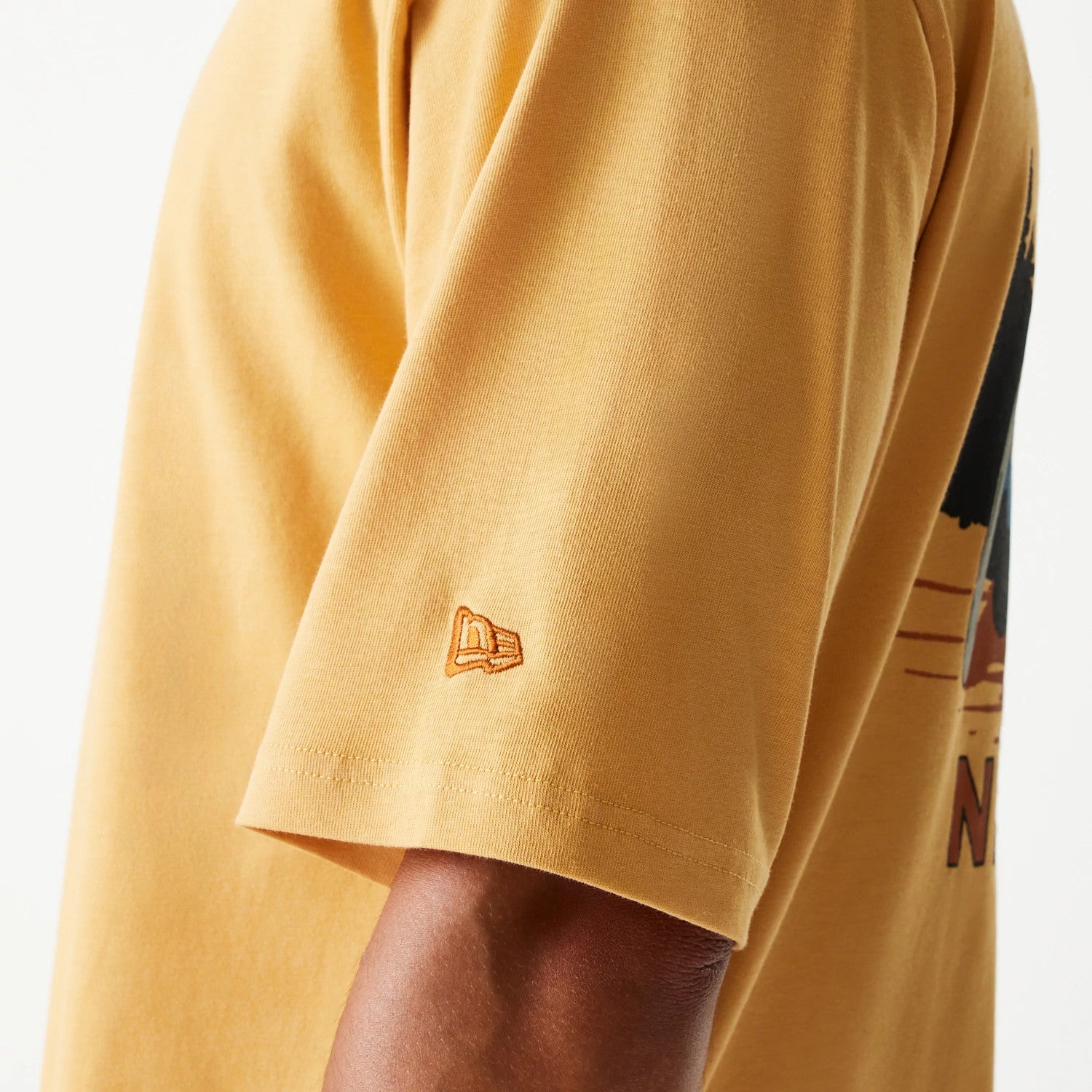 The Male model is wearing New Era Vacation Graphic Beige Oversized T-Shirt 6