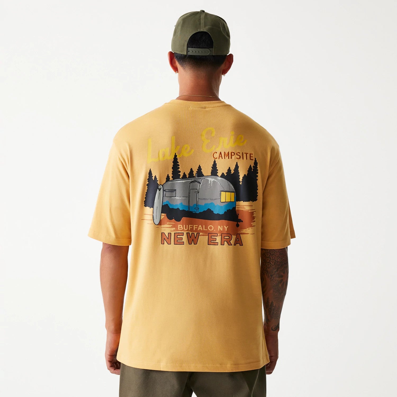 The Male model is wearing New Era Vacation Graphic Beige Oversized T-Shirt 2