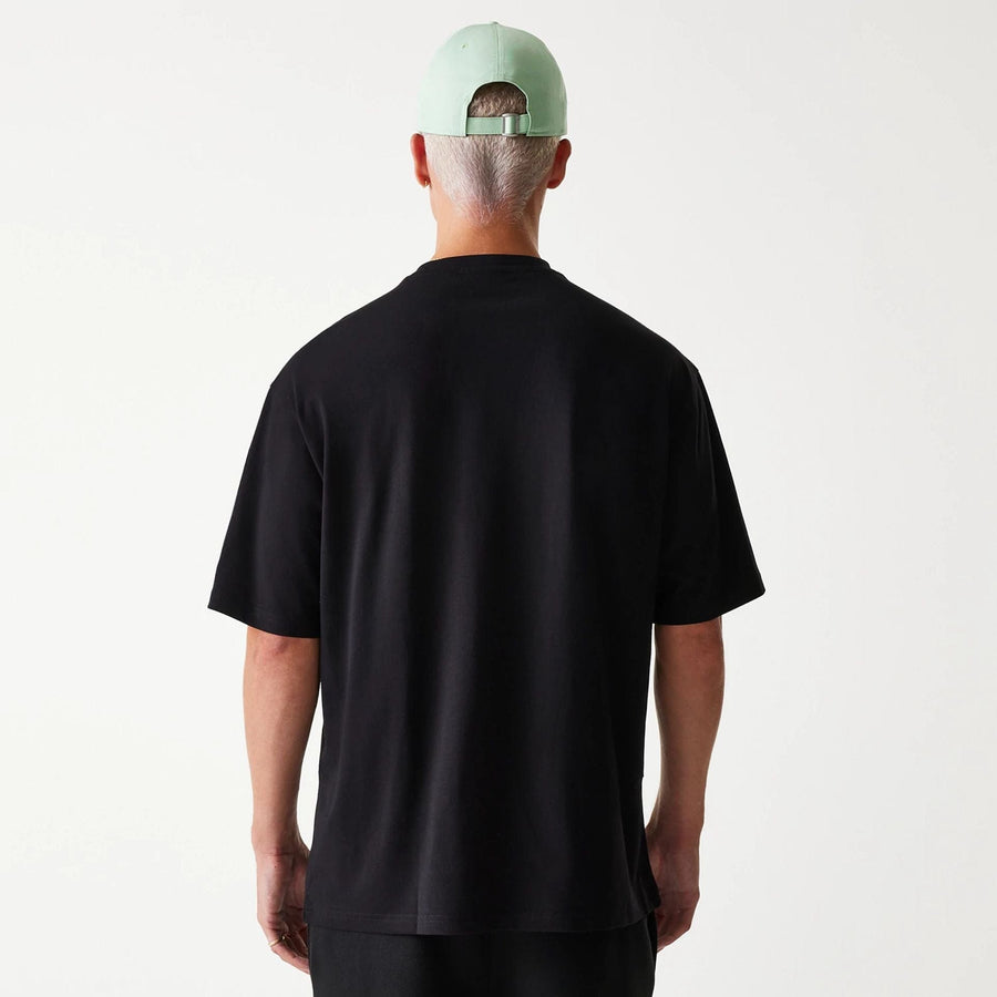 The Male model is wearing New Era Outdoor Graphic Black Oversized T-Shirt 2
