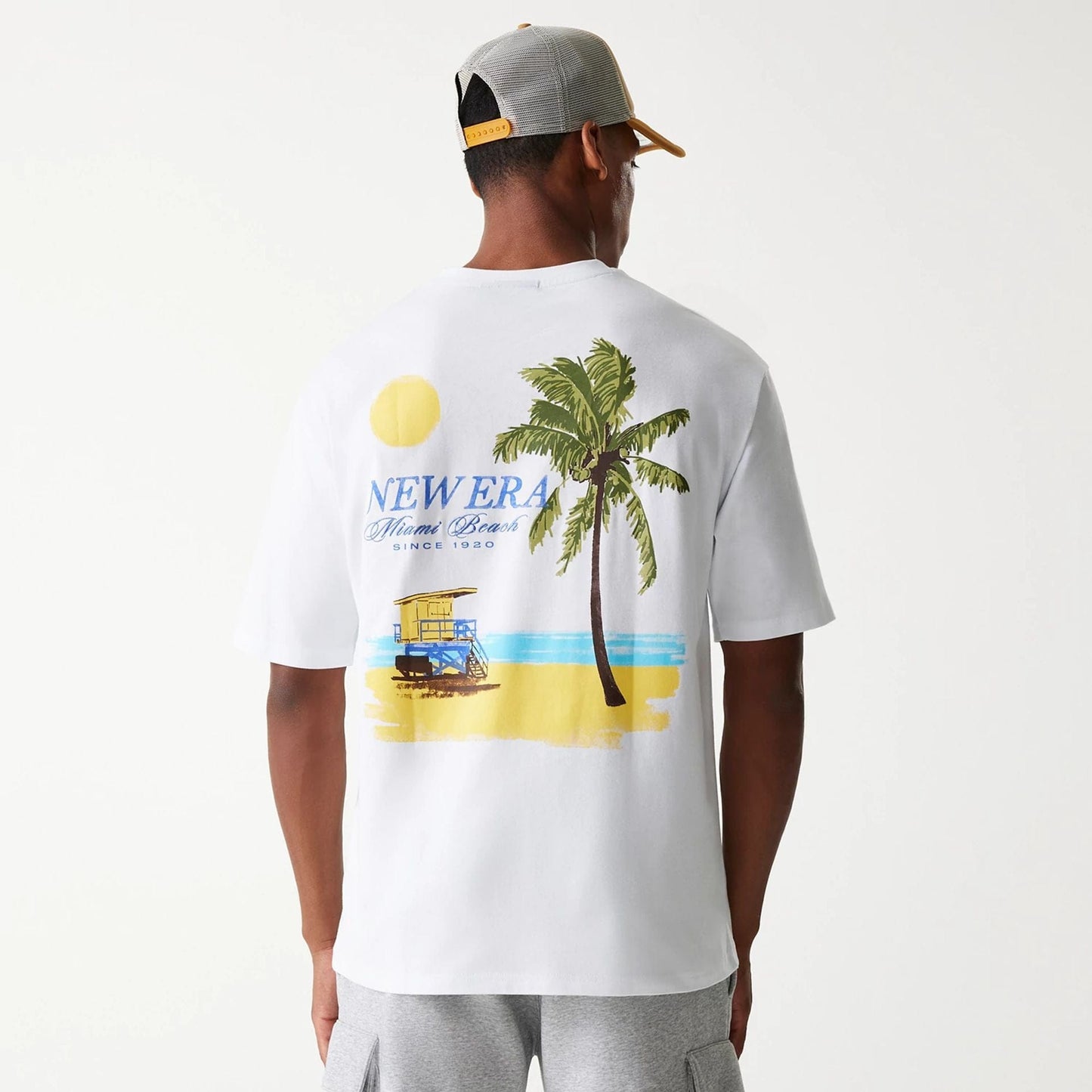 The Male model is wearing New Era Vacation Graphic White Oversized T-Shirt 3