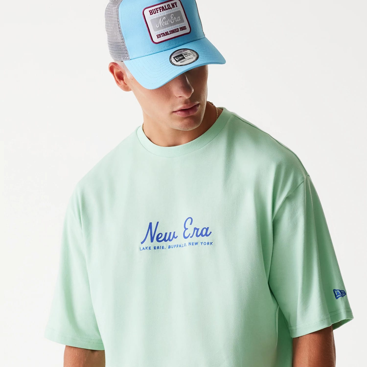 The Male model is wearing New Era Vacation Graphic Pastel Green Oversized T-Shirt 6