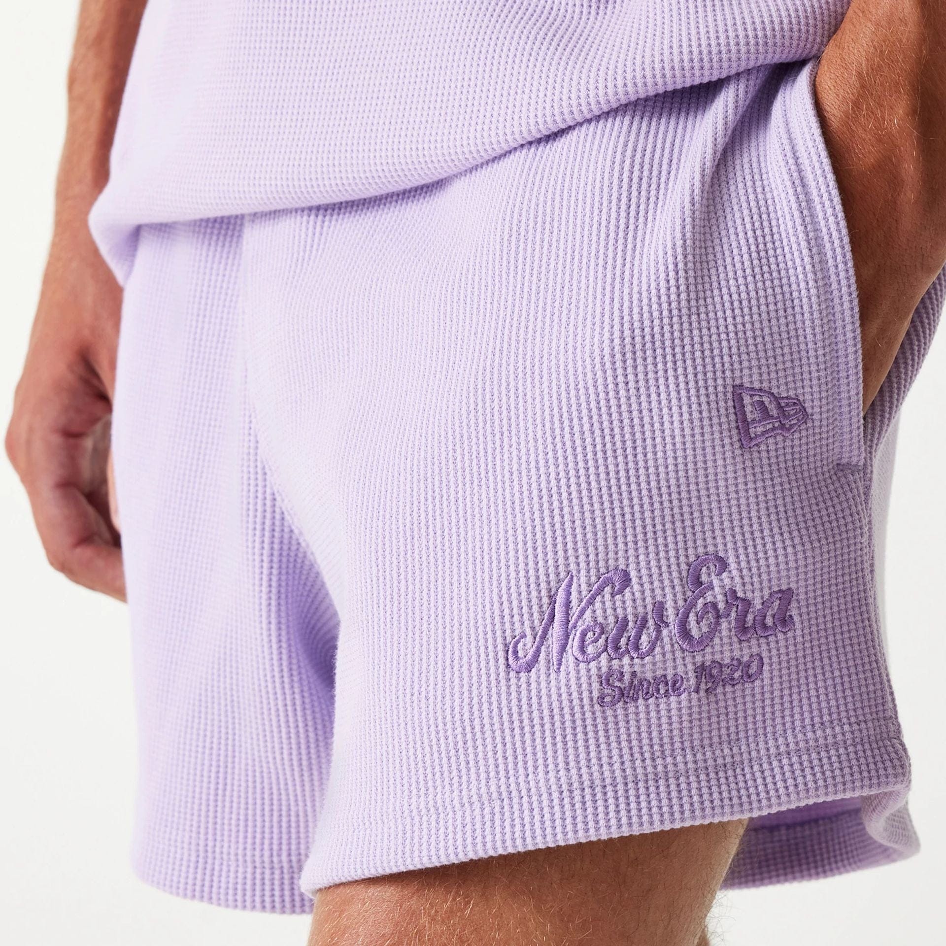 The Male model is wearing New Era Waffle Pastel Purple Shorts 4