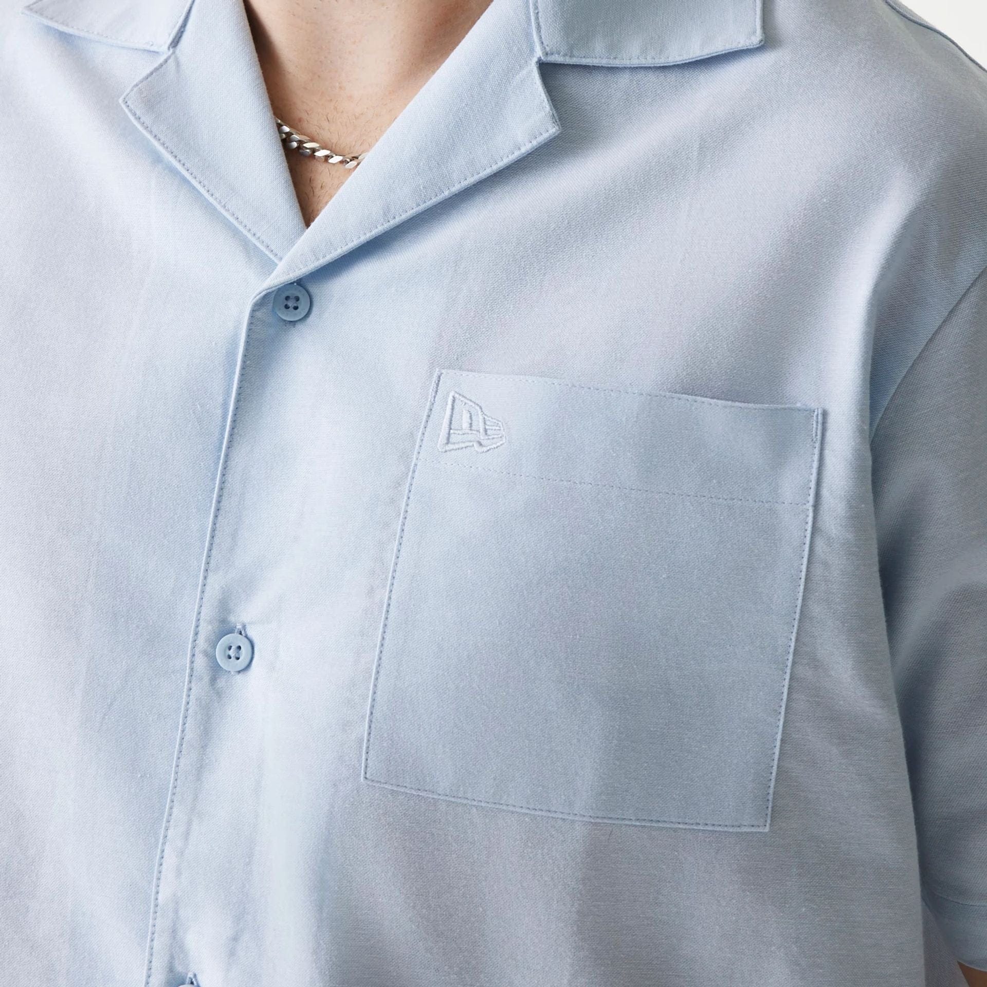 The Male model is wearing New Era Pastel Blue Revere Short Sleeve Shirt 4