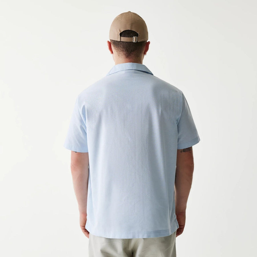 The Male model is wearing New Era Pastel Blue Revere Short Sleeve Shirt 2
