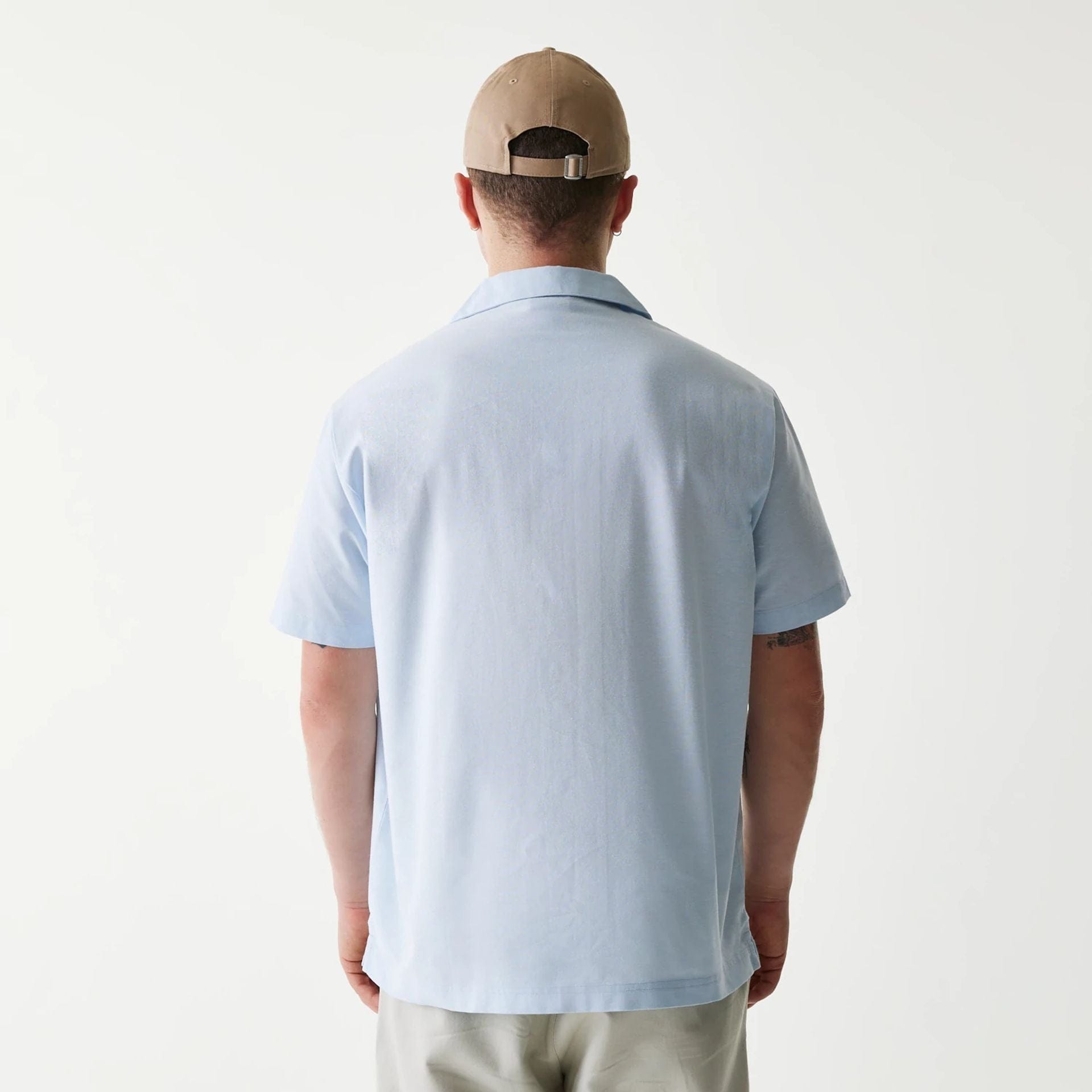 The Male model is wearing New Era Pastel Blue Revere Short Sleeve Shirt 2