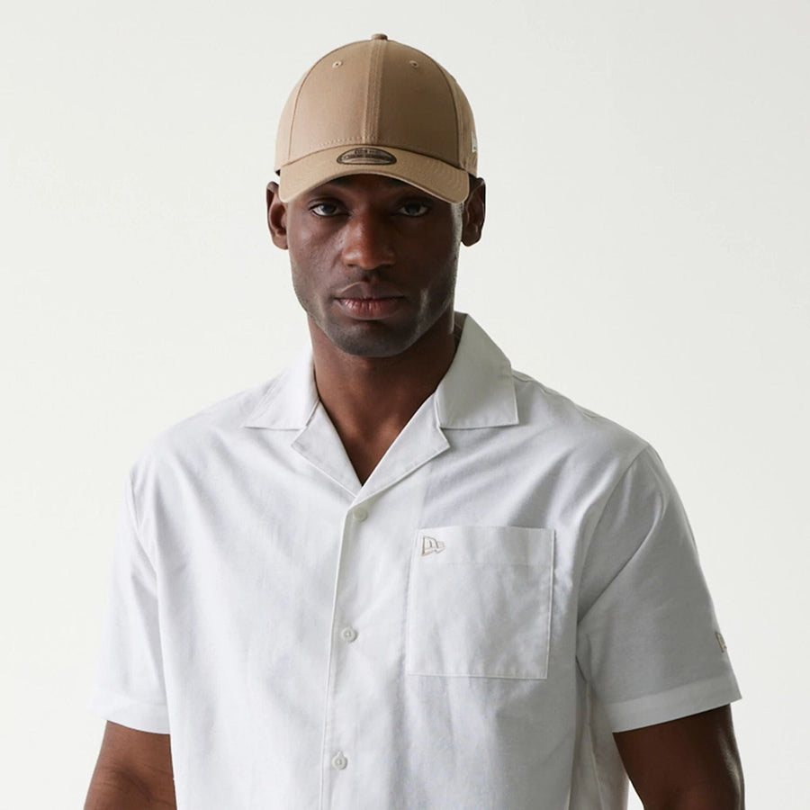 The Male model is wearing New Era White Revere Short Sleeve Shirt 6