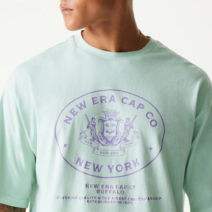 The Male model is wearing New Era Crest Pastel Green Oversized T-Shirt 6