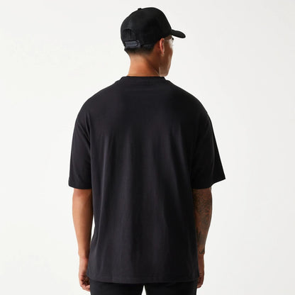 The Male model is wearing New Era Crest Black Oversized T-Shirt 2