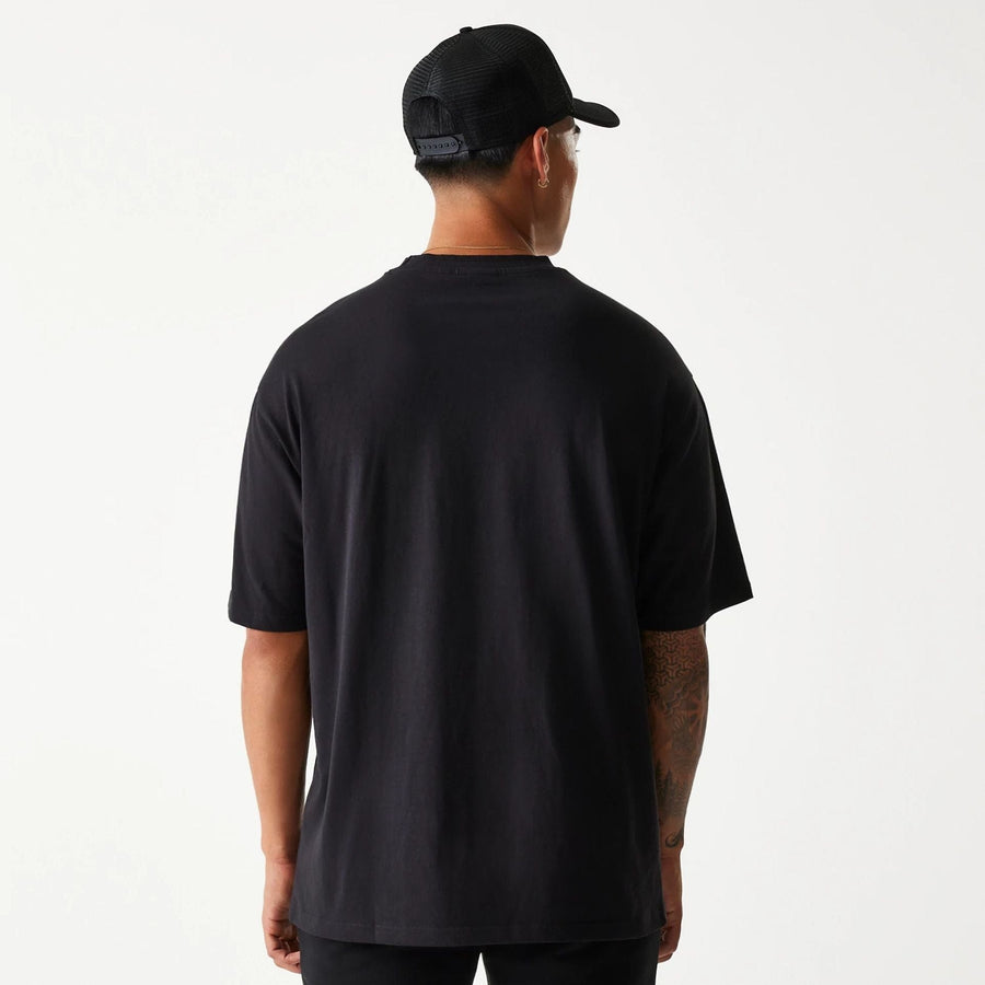 The Male model is wearing New Era Crest Black Oversized T-Shirt 2