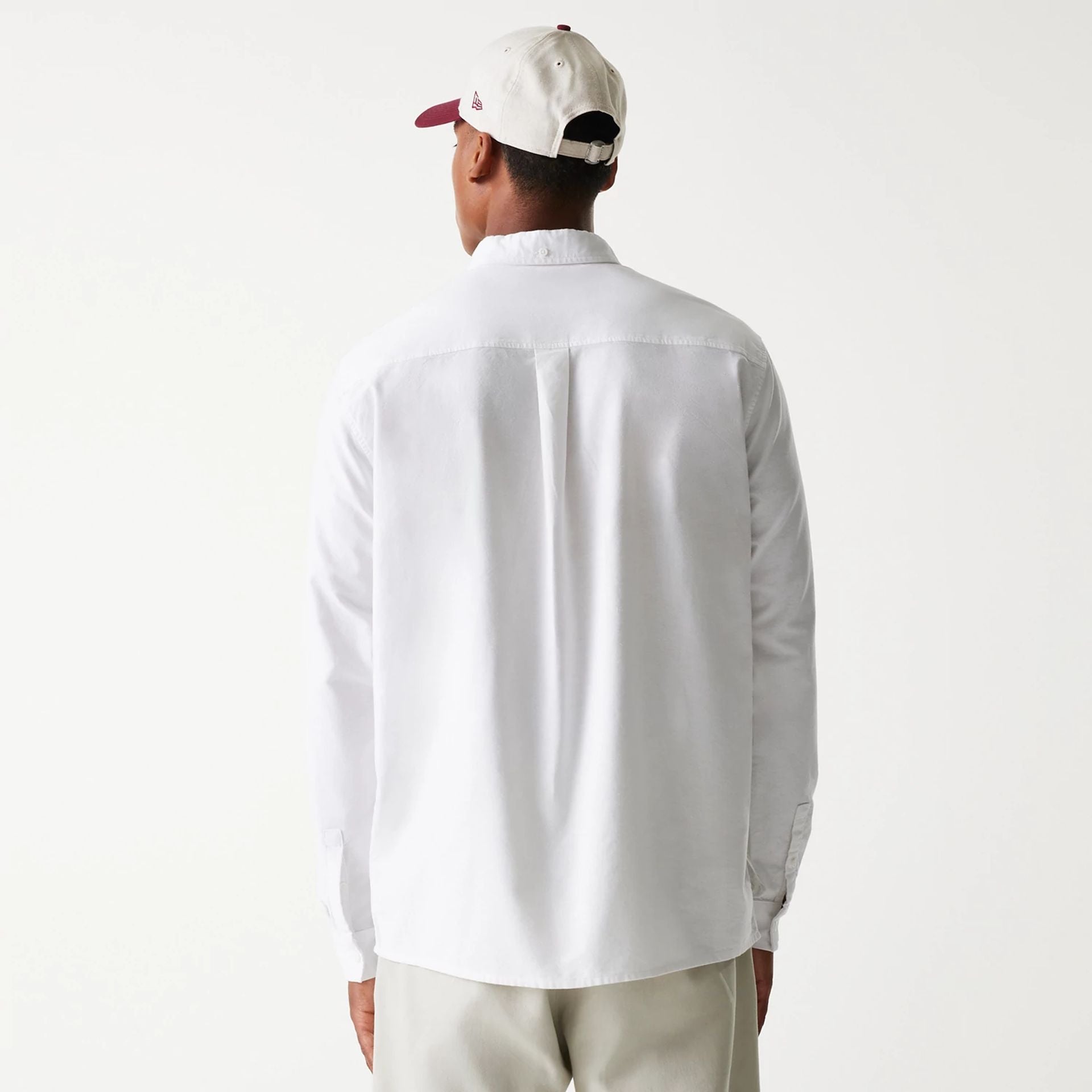The Male model is wearing New Era White Long Sleeve Shirt 2
