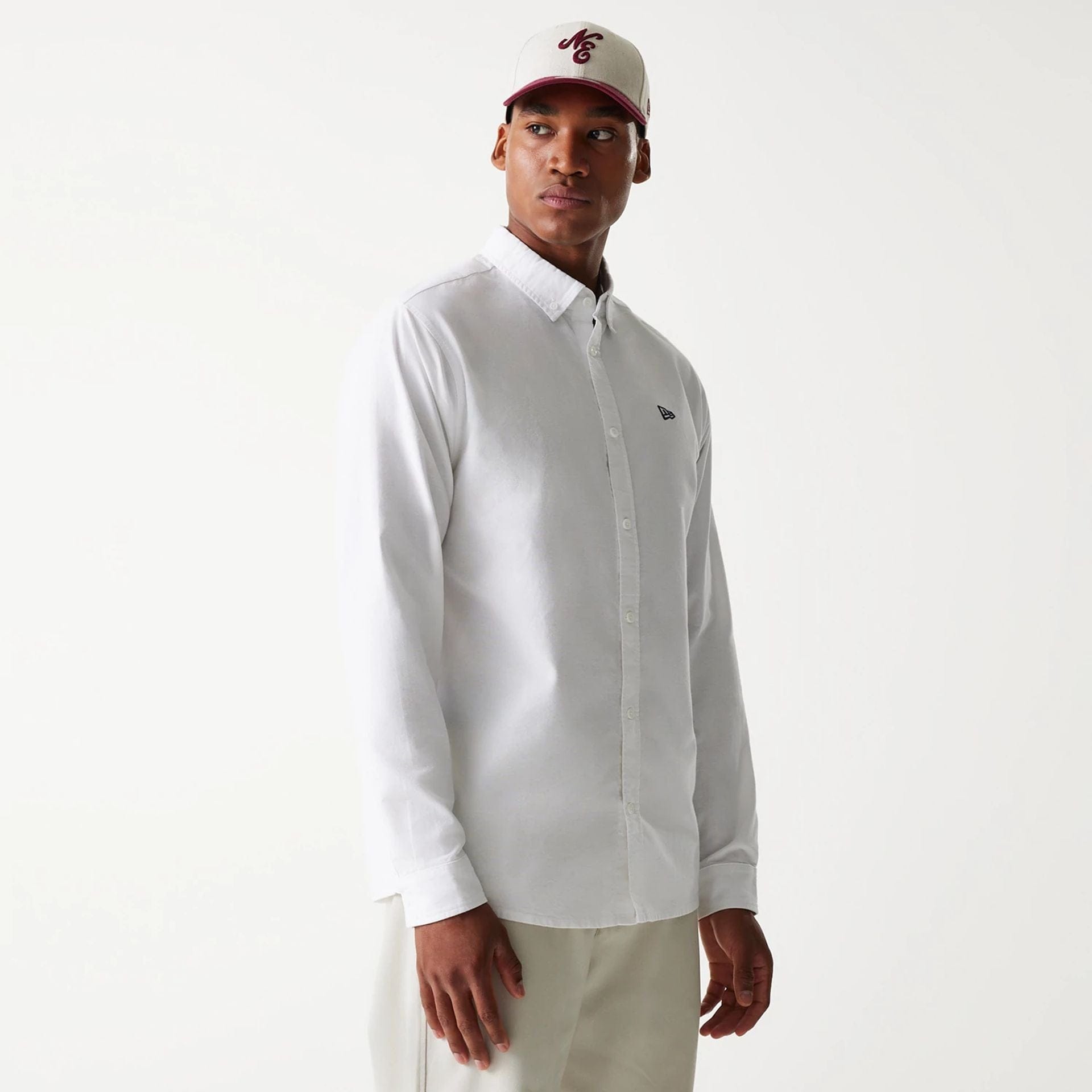 The Male model is wearing New Era White Long Sleeve Shirt 1