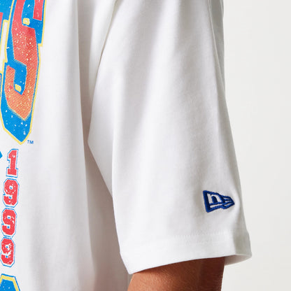 New Era New York Yankees MLB World Series 1999 White Oversized T-Shirt, side view showing a white sleeve with a raised blue New Era logo near the hem and part of a colourful graphic reading 1999 on the body of the T-shirt.