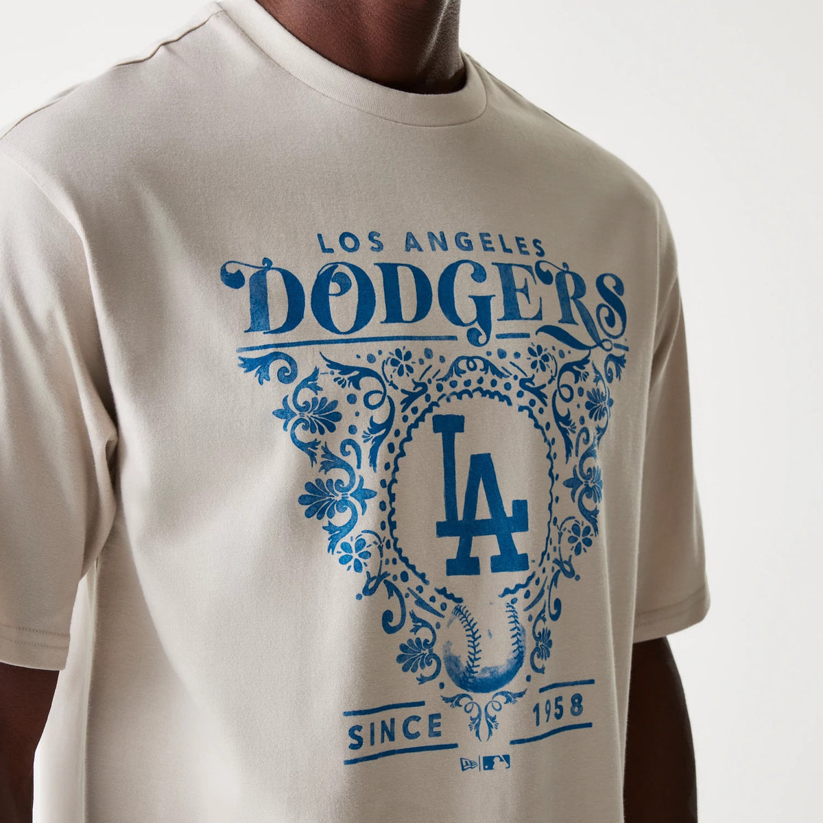 New Era LA Dodgers MLB Floral Graphic Cream Oversized T-Shirt, front view showing a large blue floral graphic with Los Angeles Dodgers and the LA logo centrally placed on a cream fabric.