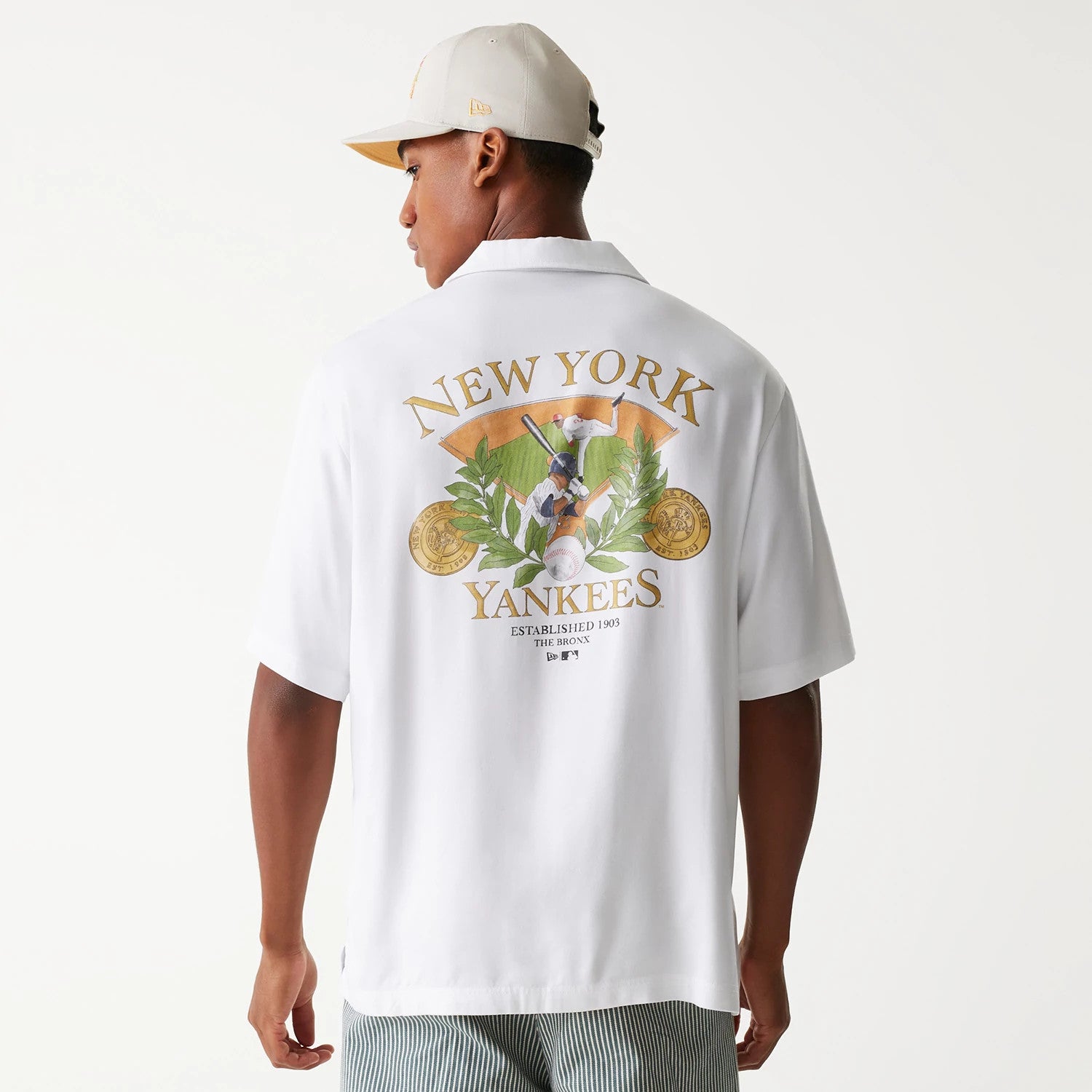 The Male model is wearing New York Yankees MLB Graphic White Revere Short Sleeve Shirt 2