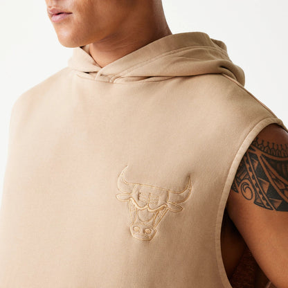 New Era Chicago Bulls NBA Washed Beige Sleeveless Hoodie, on-model view showing a close-up of the beige sleeveless hoodie with an embossed Chicago Bulls logo on the left chest area and the hood draped back.