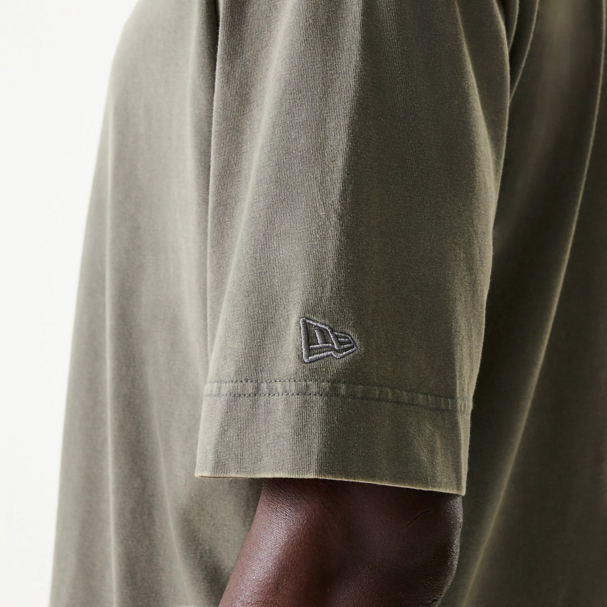New Era LA Lakers NBA Washed Grey Box T-Shirt, side view showing the grey fabric of the sleeve with a raised New Era logo in dark stitching near the hem.