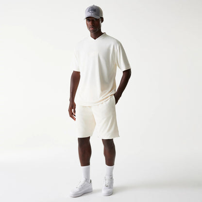 New Era LA Lakers NBA Tonal Open White Mesh Shorts, on-model view showing the relaxed fit white shorts paired with a coordinating white T-shirt, highlighting the tonal LA Lakers motifs.