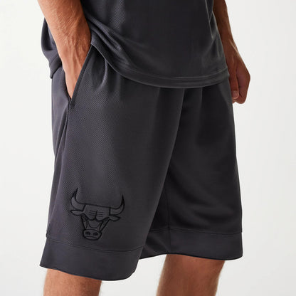 New Era Chicago Bulls NBA Tonal Dark Grey Mesh Shorts, side view displaying a dark grey mesh fabric with a raised Chicago Bulls logo on the lower left leg and a relaxed fit.