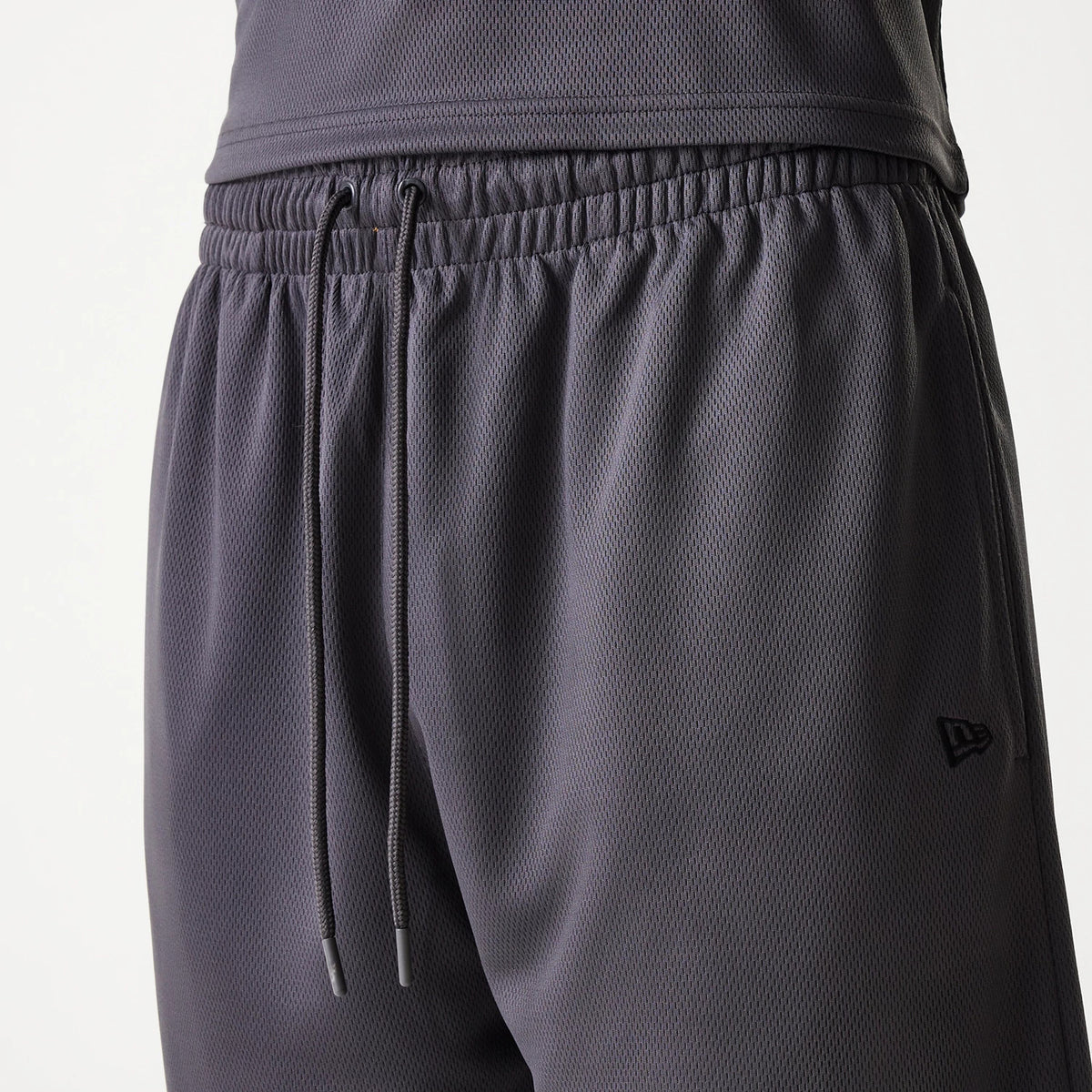 New Era Chicago Bulls NBA Tonal Dark Grey Mesh Shorts, front view showing the elastic waistband with adjustable drawstrings, and an embossed New Era logo positioned on the lower right side.
