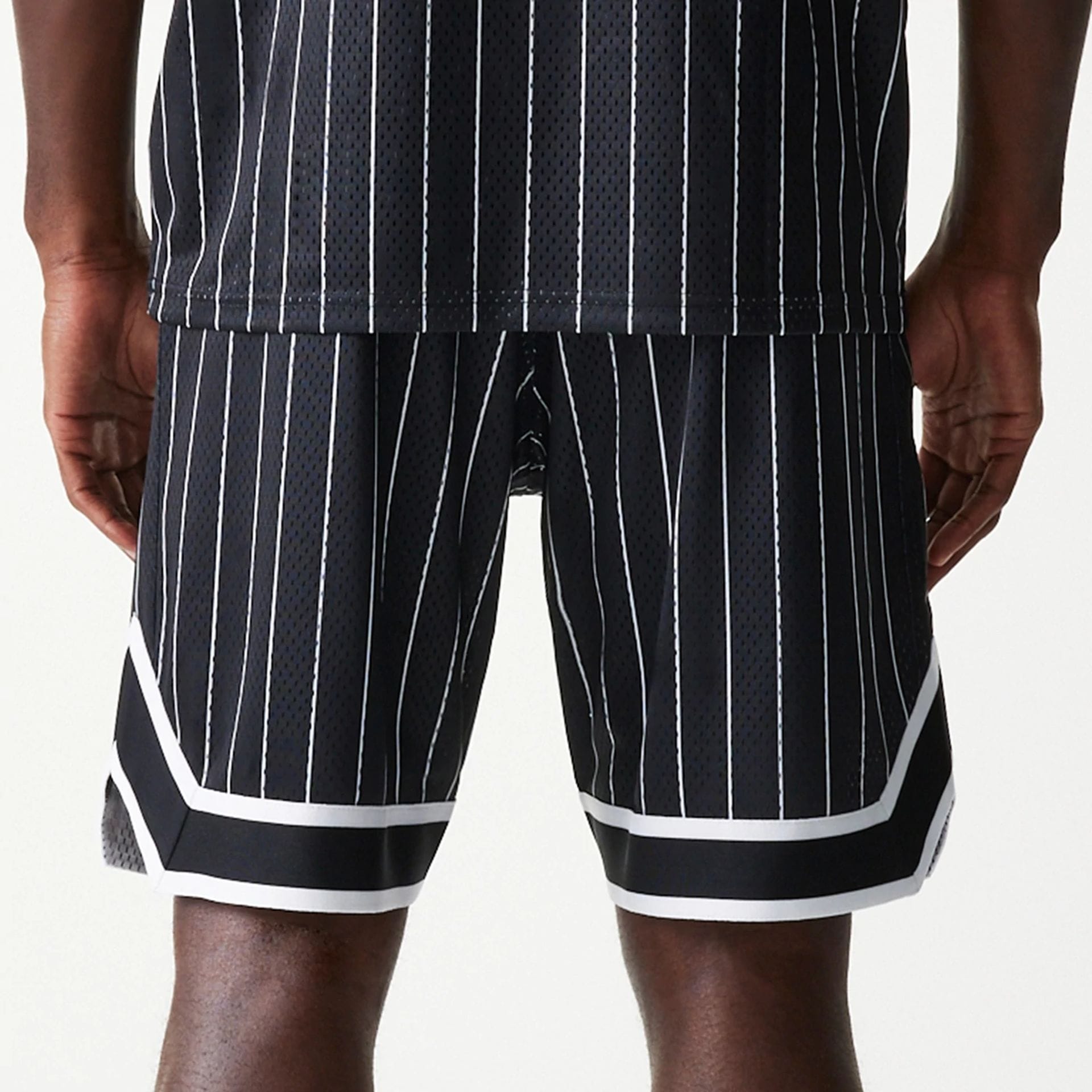 The Male model is wearing Las Vegas Raiders NFL Pinstripe Black Shorts 2