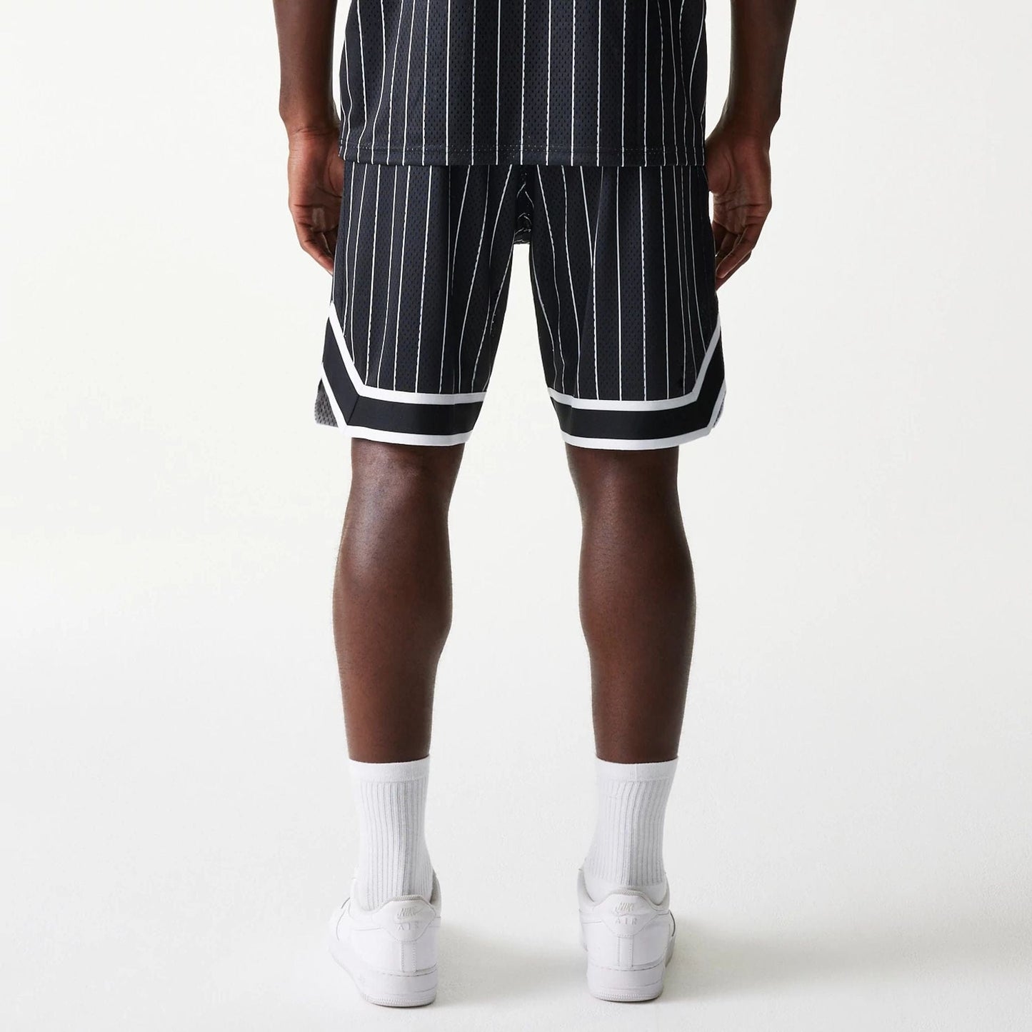 The Male model is wearing Las Vegas Raiders NFL Pinstripe Black Shorts 6