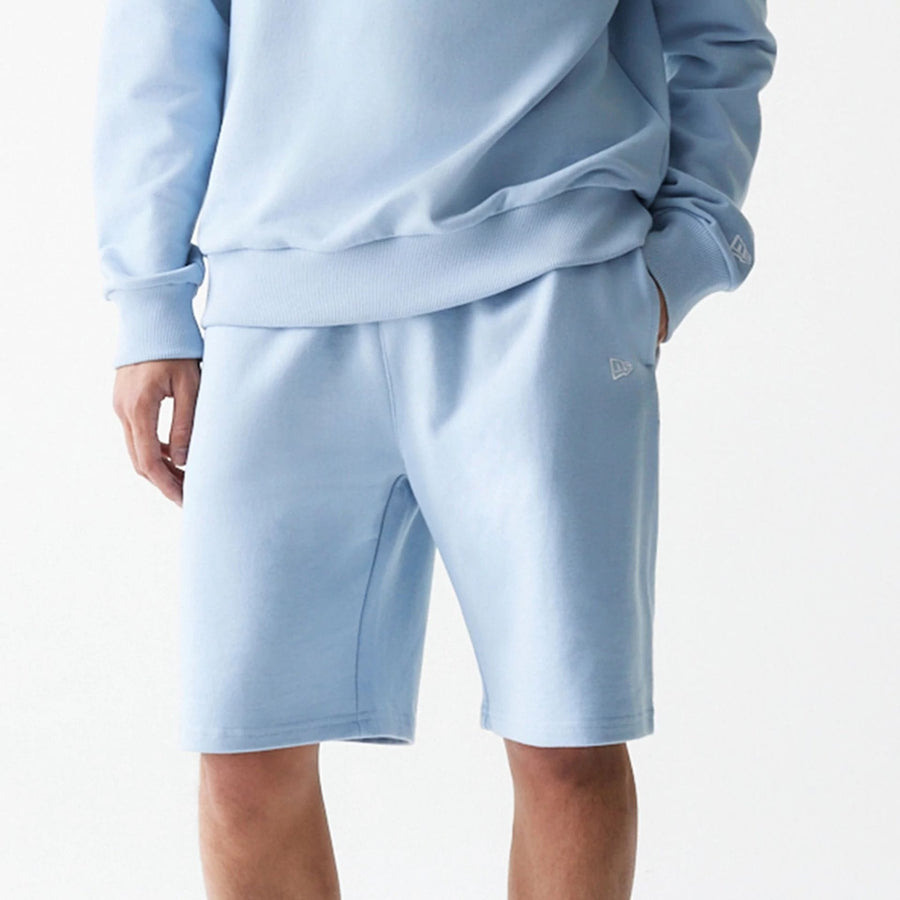 The Male model is wearing New Era Pastel Blue Oversized One Panel Shorts 3