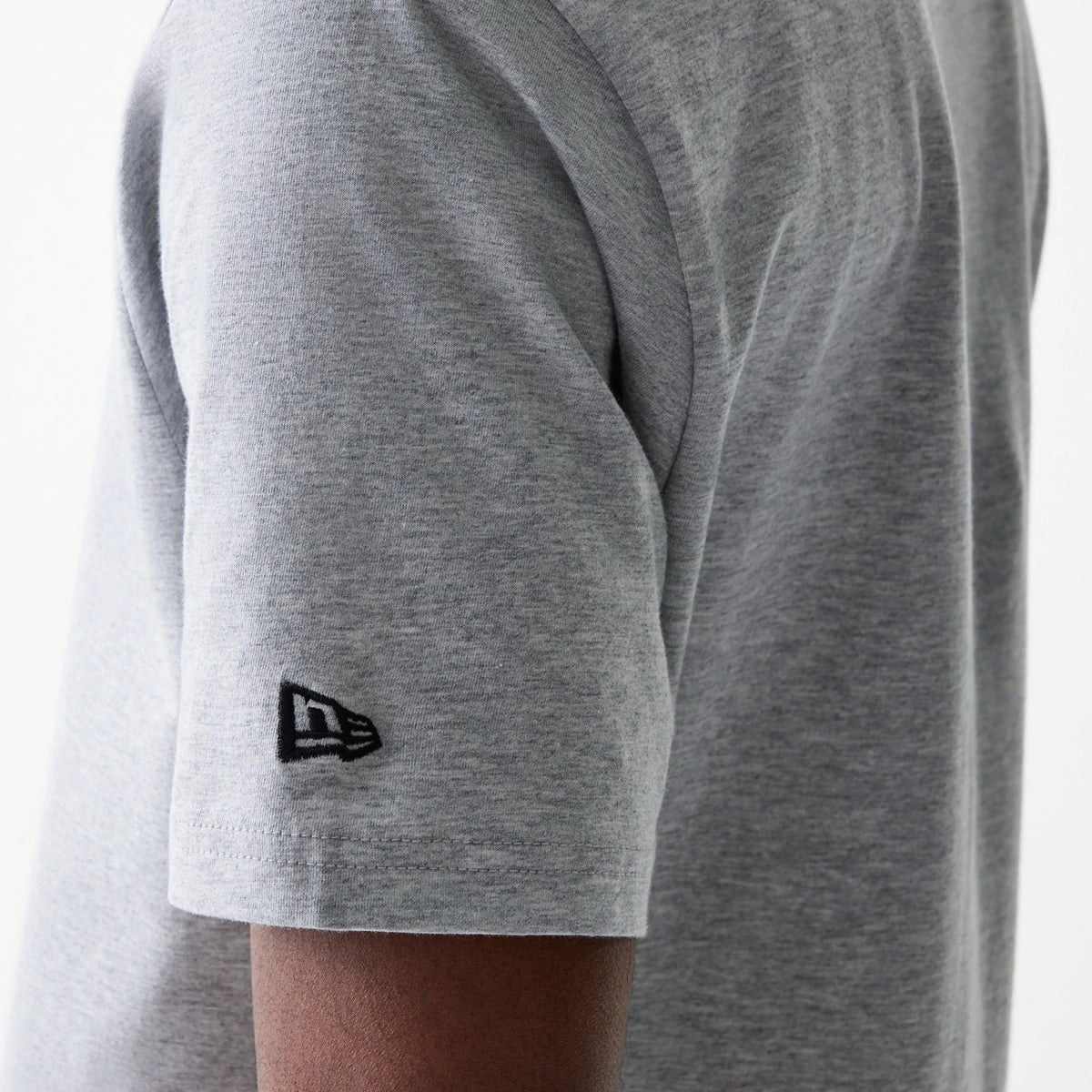 New Era LA Lakers NBA Logo Grey T-Shirt, side view showing the short sleeve with a raised black New Era logo embroidered near the cuff on the smooth grey fabric.
