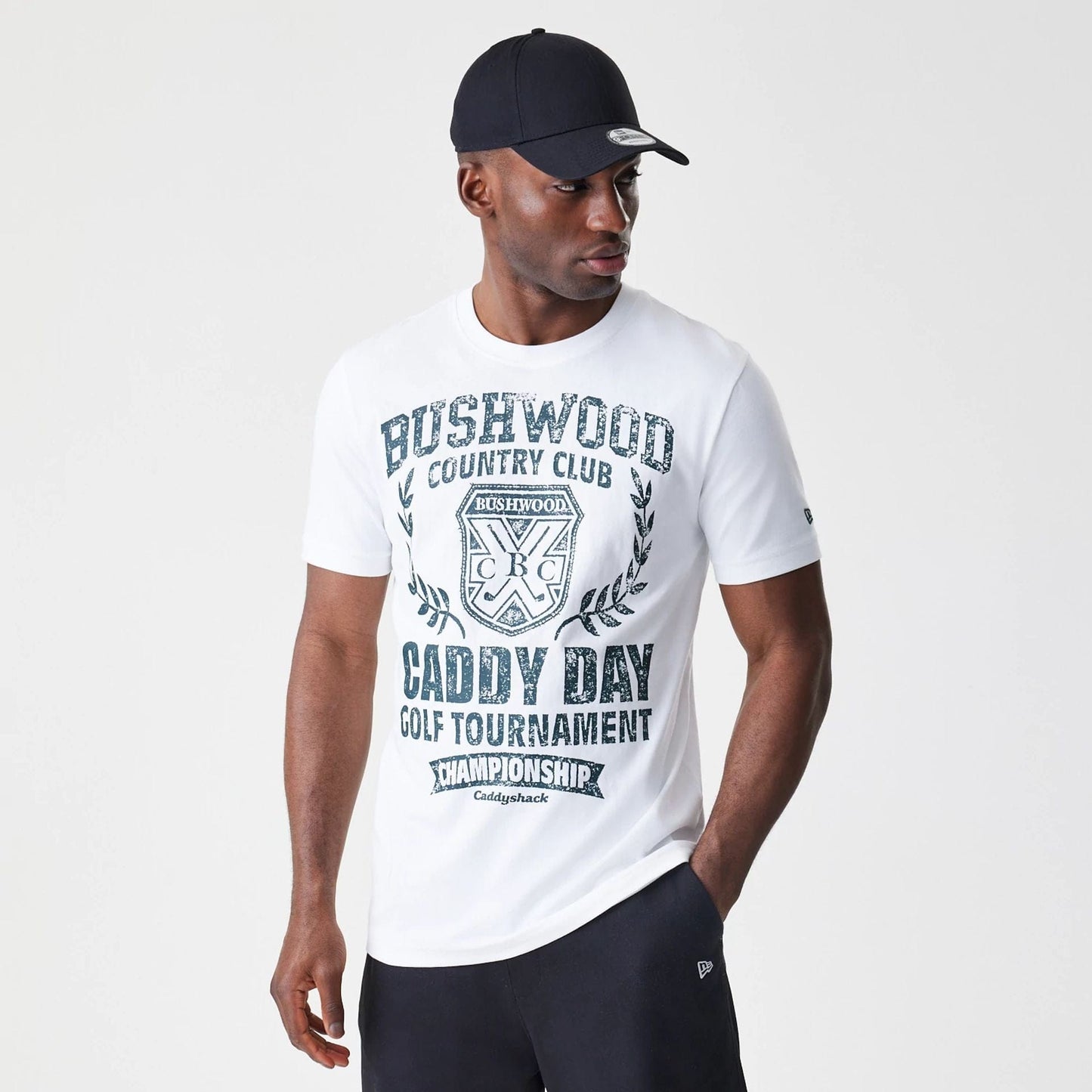 The Male model is wearing Caddyshack Caddy Day Tournament White T-Shirt 1