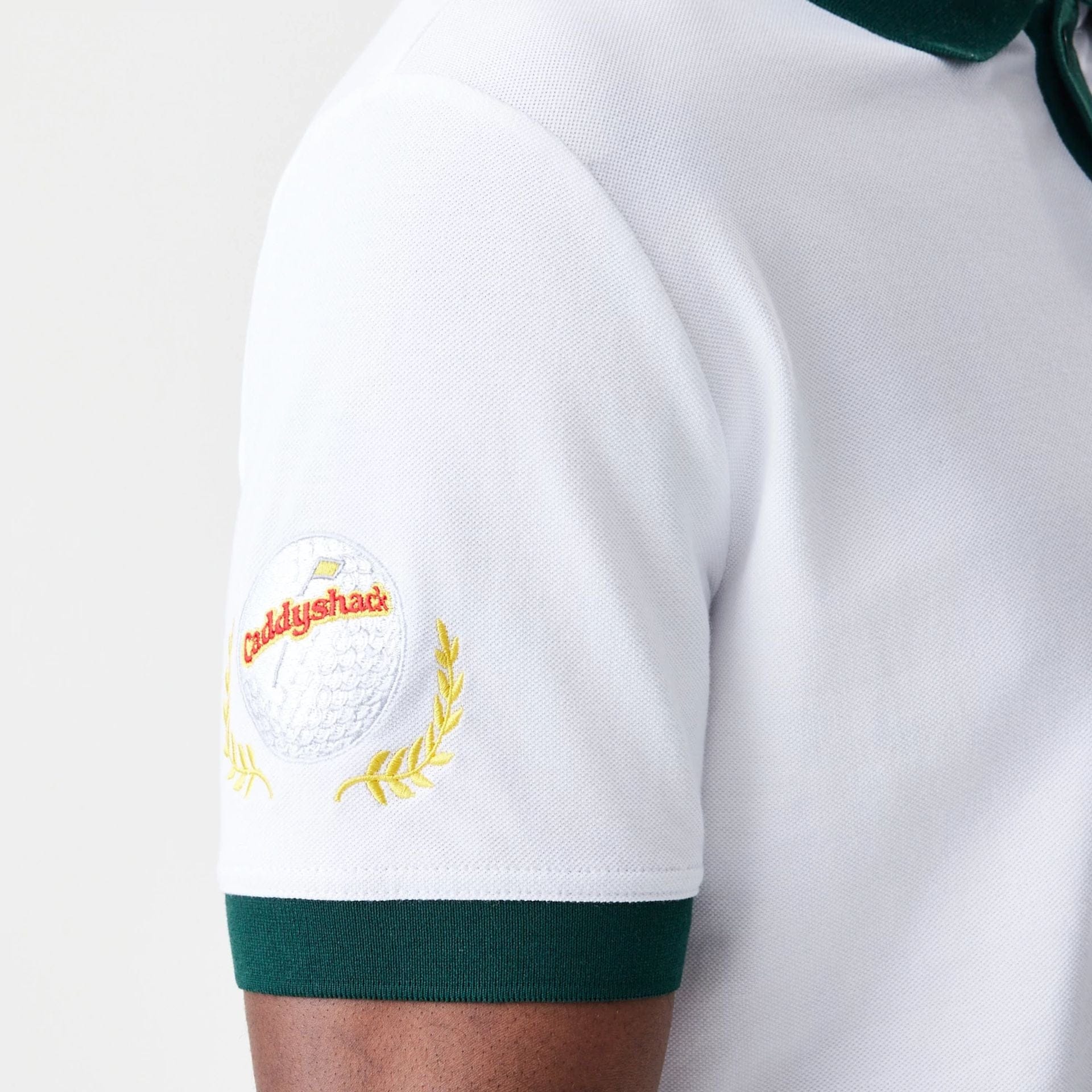 The Male model is wearing Caddyshack BushWood White Polo T-Shirt 5