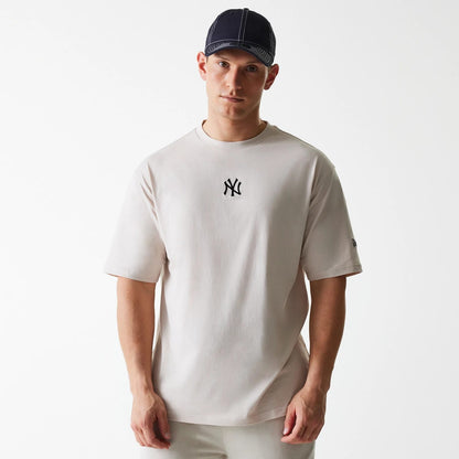 The Male model is wearing New York Yankees MLB League Essential Cream Oversized T-Shirt 1