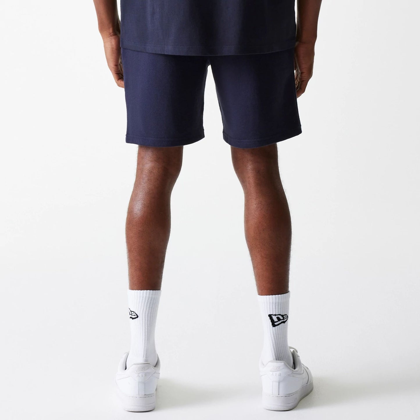 The Male model is wearing New York Yankees MLB League Essential Navy Shorts 2