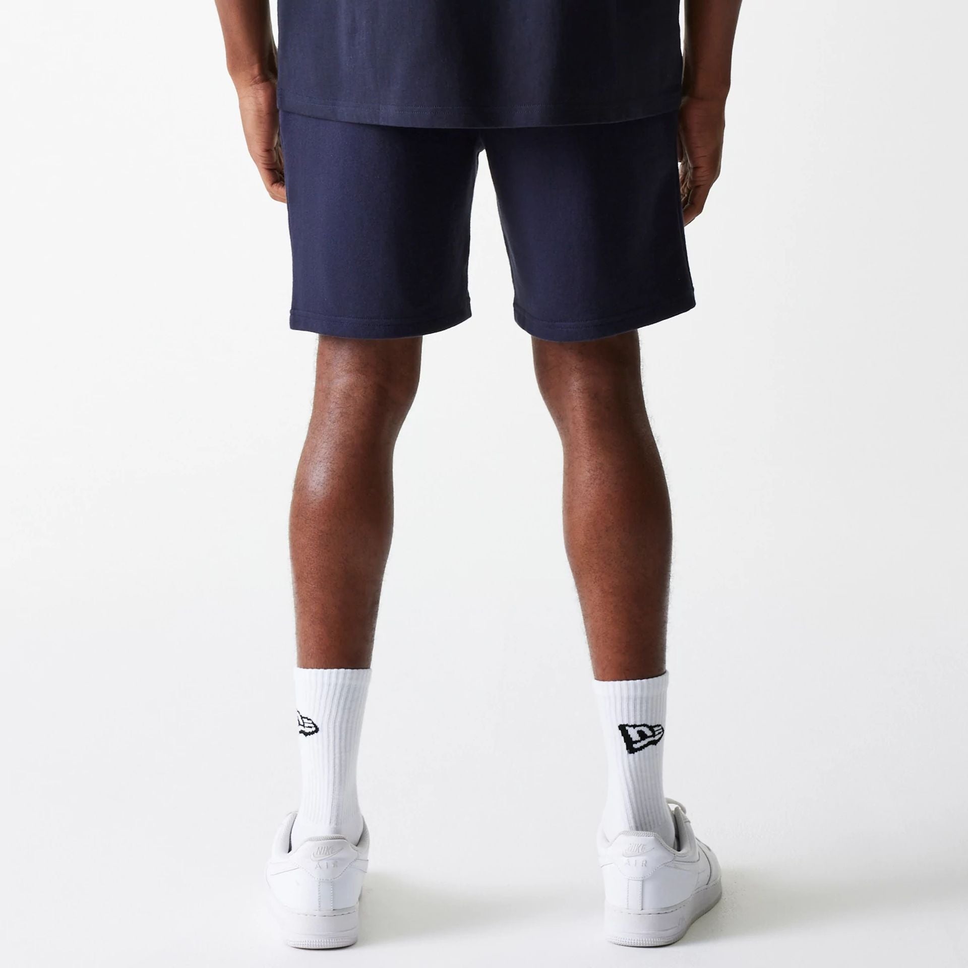 The Male model is wearing New York Yankees MLB League Essential Navy Shorts 2