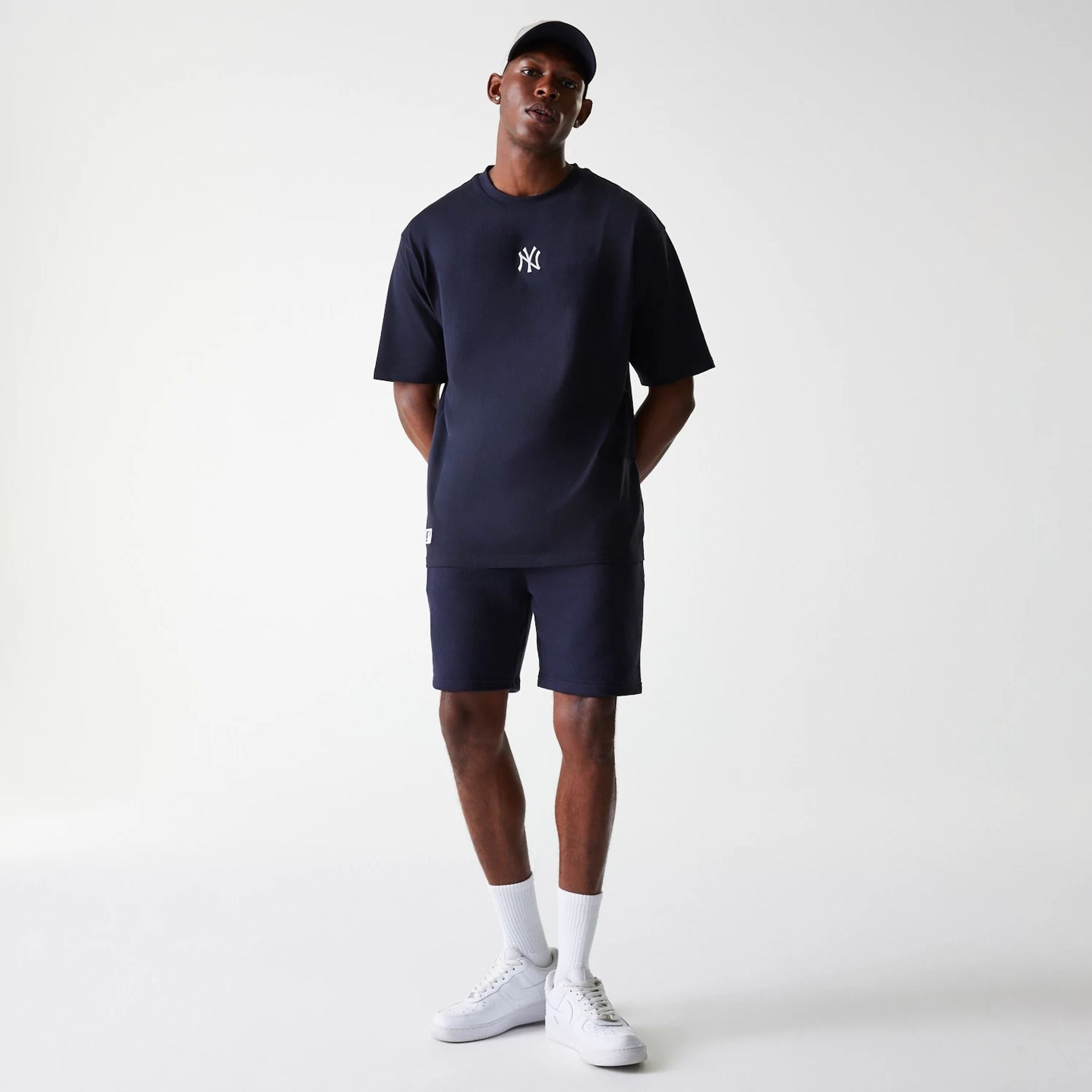 The Male model is wearing New York Yankees MLB League Essential Navy Shorts 8