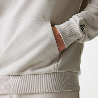 The Male model is wearing New York Yankees MLB League Essential Midi Cream Oversized Pullover Hoodie 5