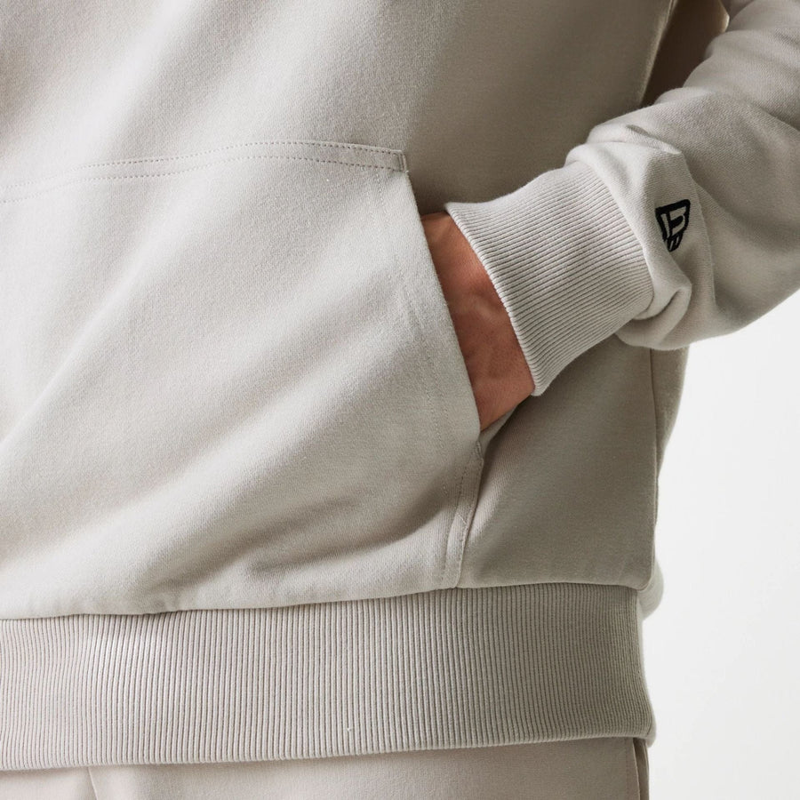 The Male model is wearing New York Yankees MLB League Essential Midi Cream Oversized Pullover Hoodie 5