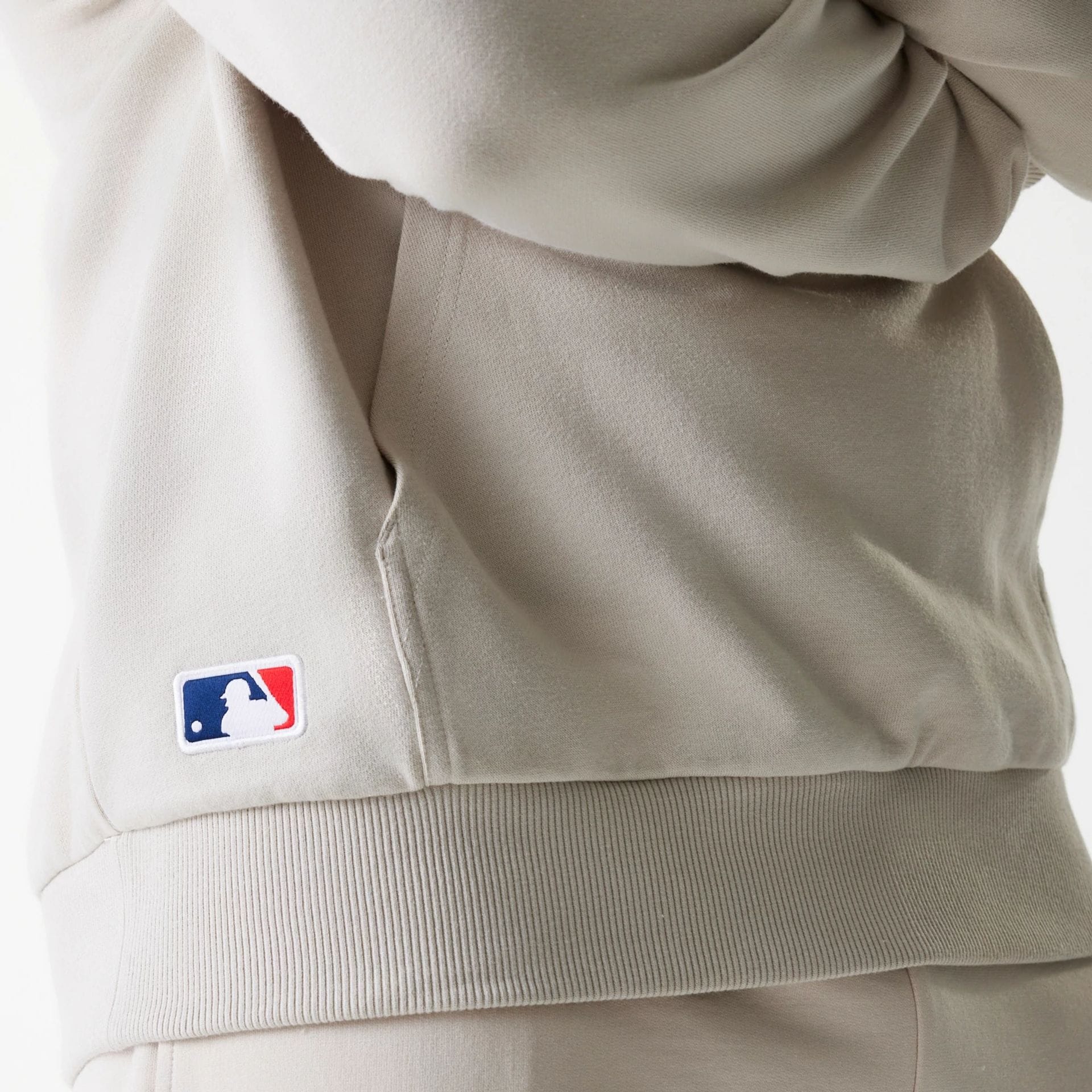 The Male model is wearing New York Yankees MLB League Essential Midi Cream Oversized Pullover Hoodie 6