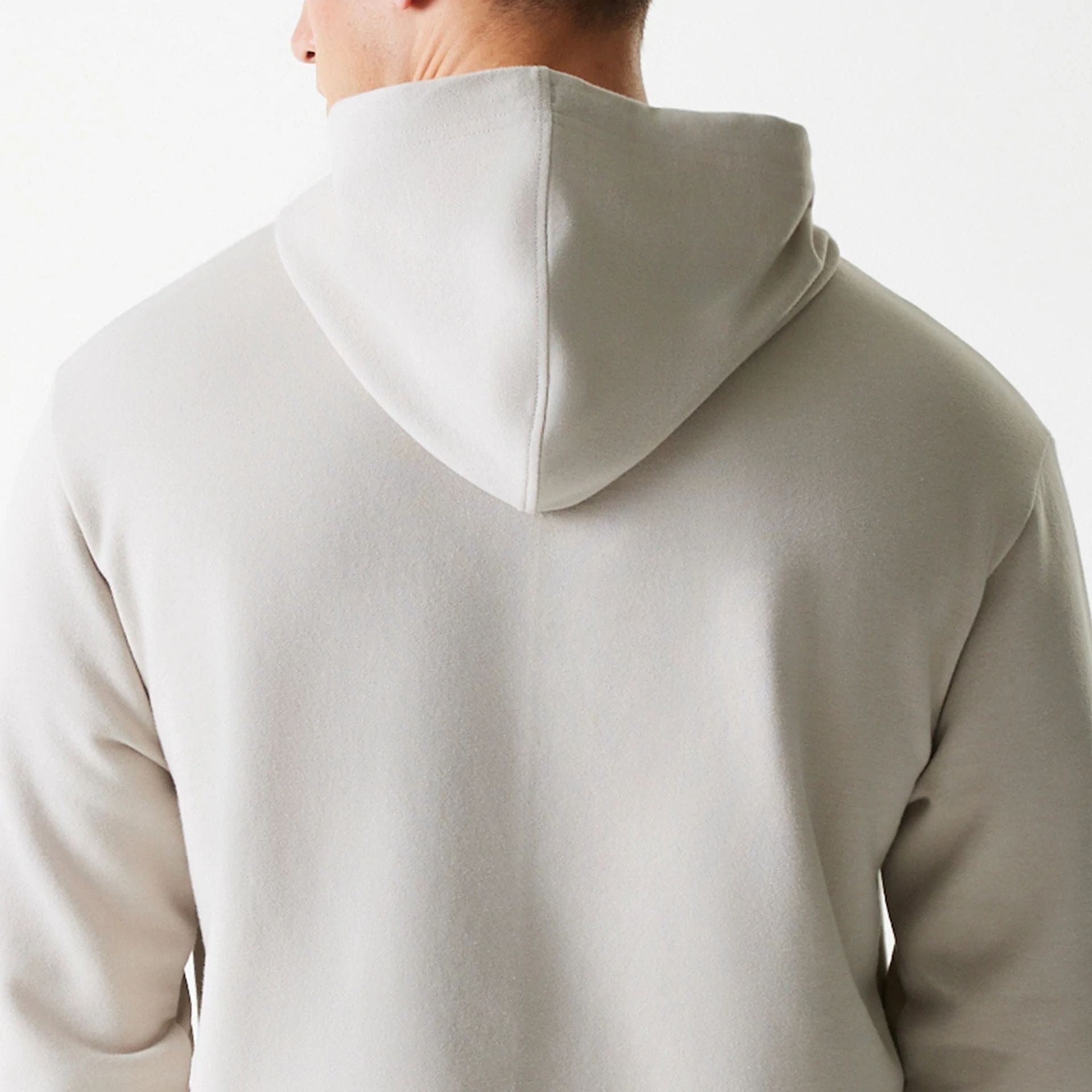 The Male model is wearing New York Yankees MLB League Essential Midi Cream Oversized Pullover Hoodie 7