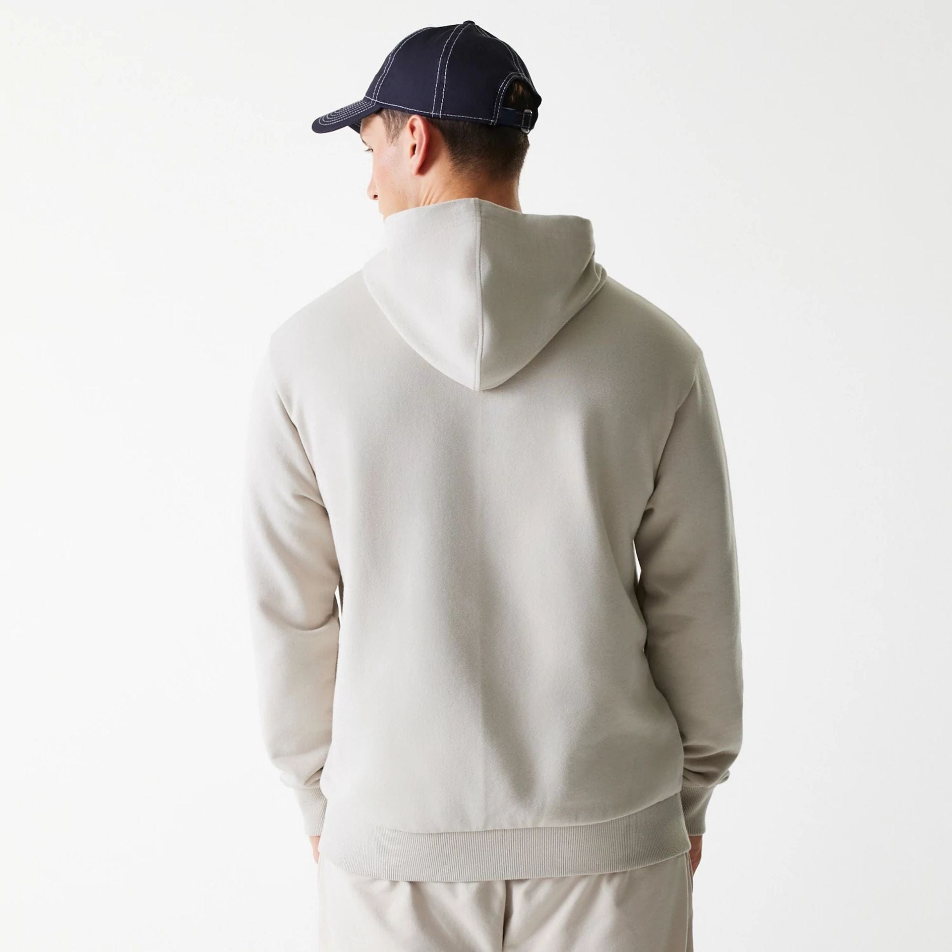 The Male model is wearing New York Yankees MLB League Essential Midi Cream Oversized Pullover Hoodie 2