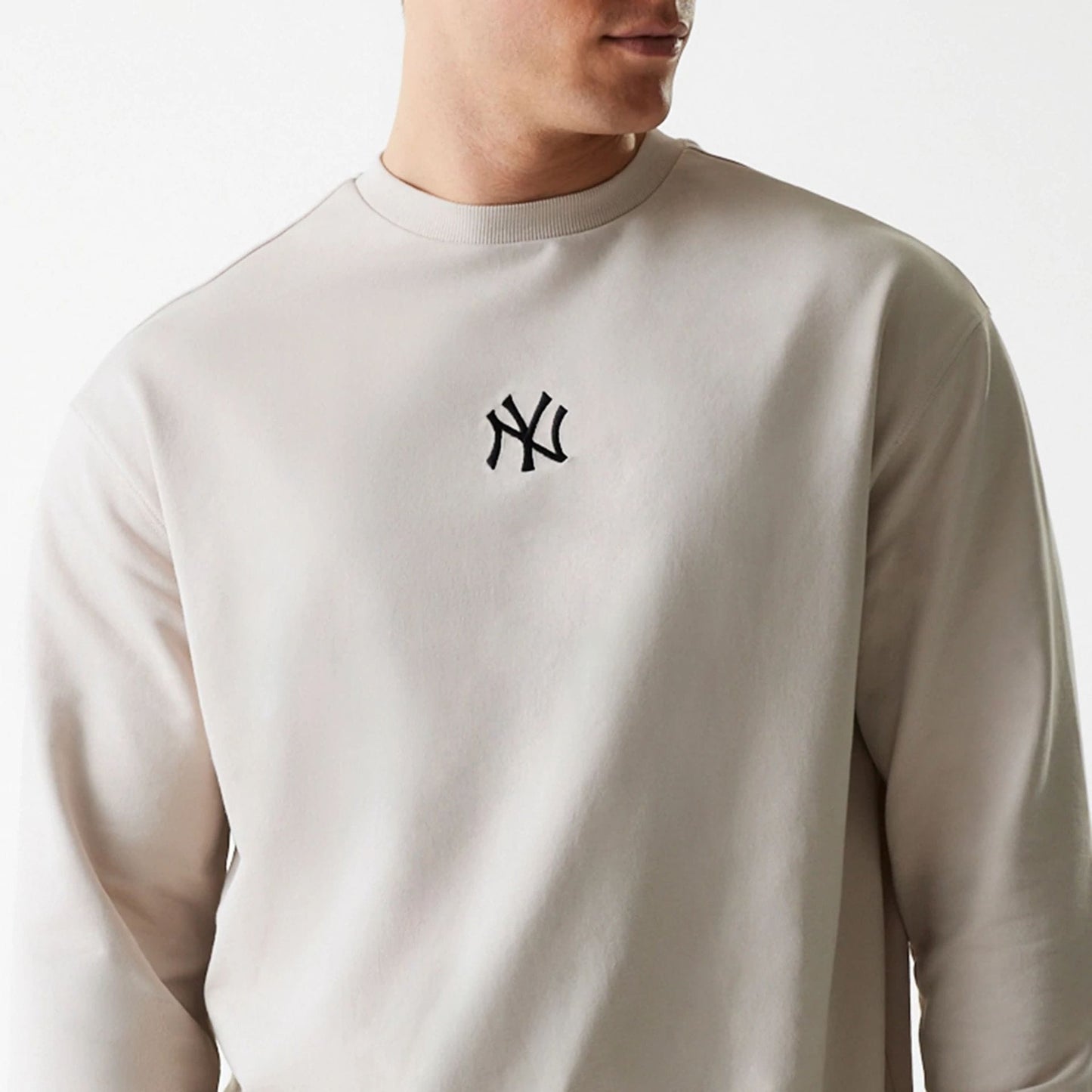 The Male model is wearing New York Yankees MLB League Essential Cream Crew Neck Sweater 3