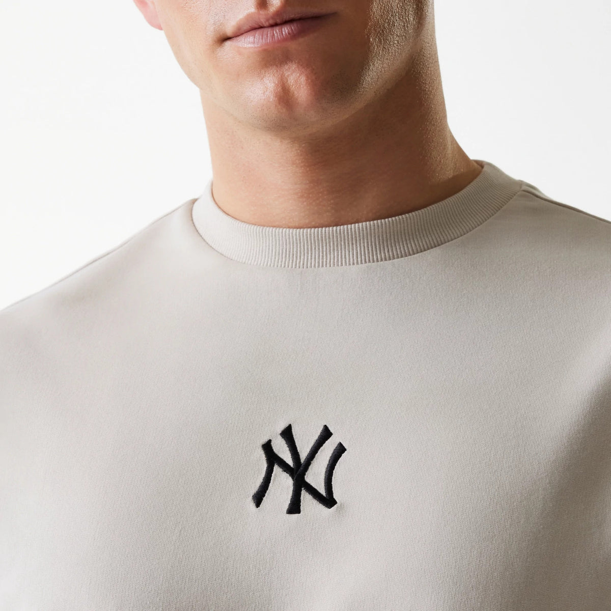 The Male model is wearing New York Yankees MLB League Essential Cream Crew Neck Sweater 4