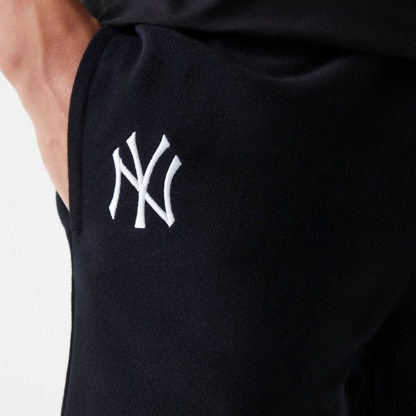 The Male model is wearing New York Yankees MLB League Essential Black Shorts 4