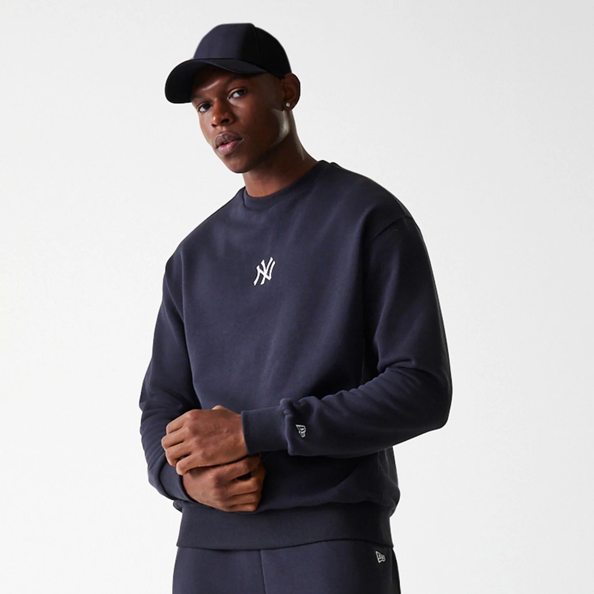 The Male model is wearing New York Yankees MLB League Essential Navy Crew Neck Sweater 3